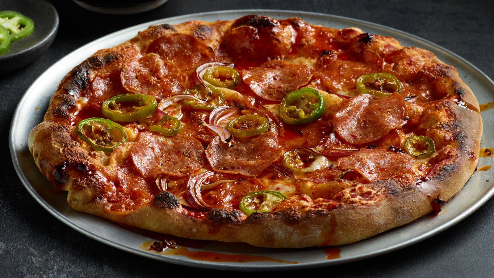 https://www.columbuscraftmeats.com/wp-content/uploads/2023/05/Web_1600_Hot-Sopressata-Red-Onion-and-Jalapeno-Pizza-with-Hot-Chili-Oil-and-Honey.jpg